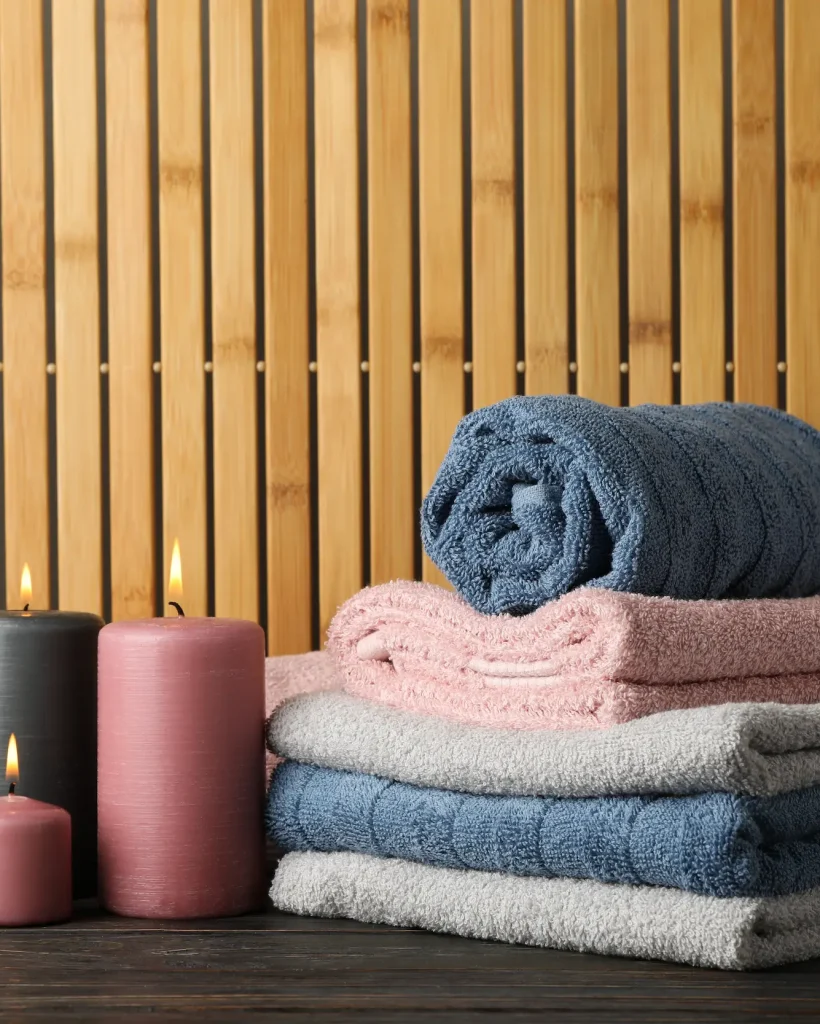 towels-candles-wooden-table-bamboo-space-text